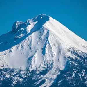 Dramatic alpine mountain peak against clear skies