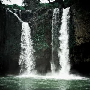 Cascading mountain waterfall surrounded by cliffs