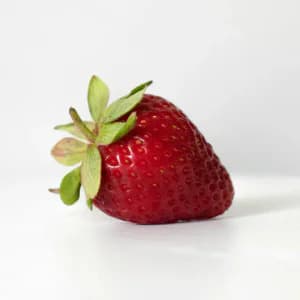Fresh ripe red strawberry with green leaves
